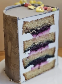 Cake cross-section showing layered cake structure with sponge layers and berry filling