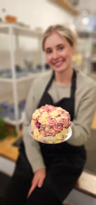 Participant holding a floral cake